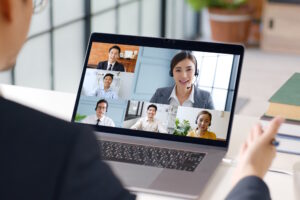 Businessman on video call with 6 other people