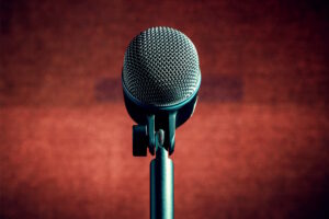 A microphone on a stand in front of a red wall